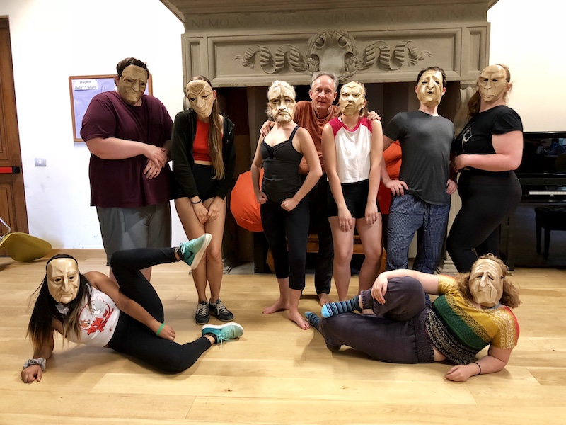 Group photo of the summer 2018 Commedia dell'Arte students wearing traditional Commedia masks, with Jacob Oleson.